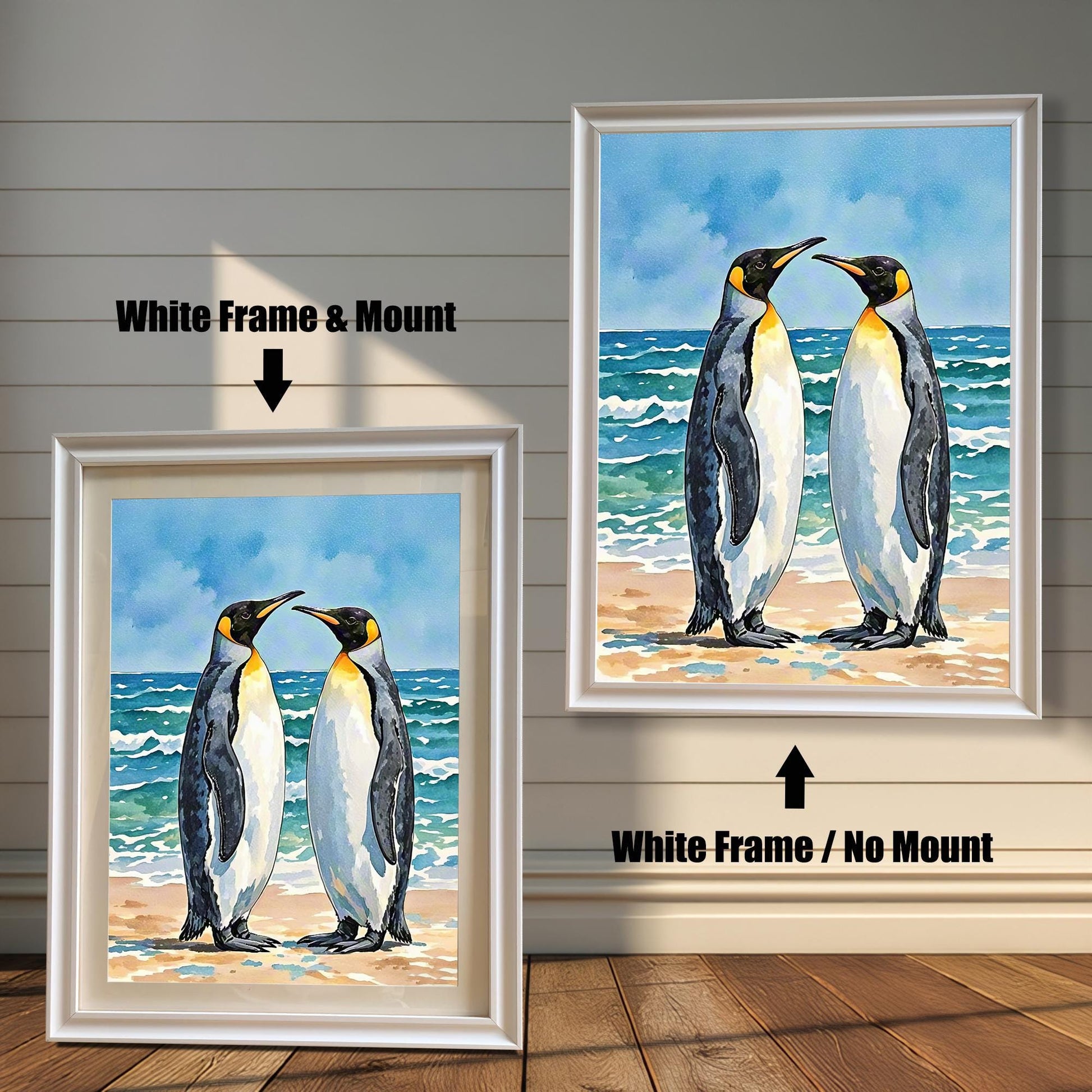 Watercolor penguin art in two white frames: "White Frame & Mount" (with mat) and "White Frame / No Mount" (no mat), against a white paneled wall.