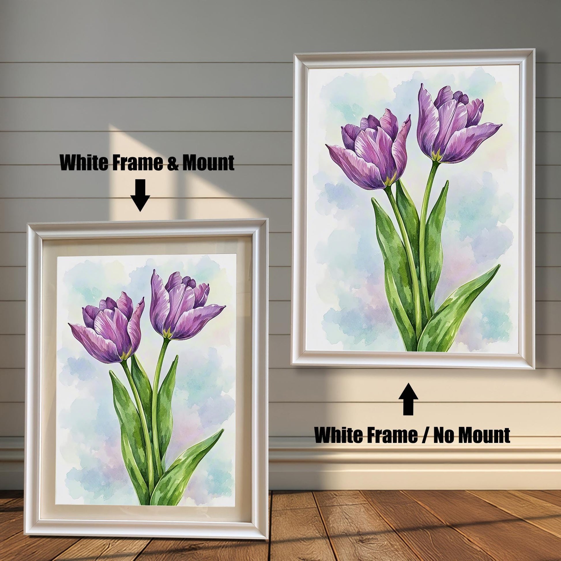 Two framed art prints of purple tulips on a wooden floor. The print on the left is in a white frame with a mount, and the one on the right is in a white frame without a mount.