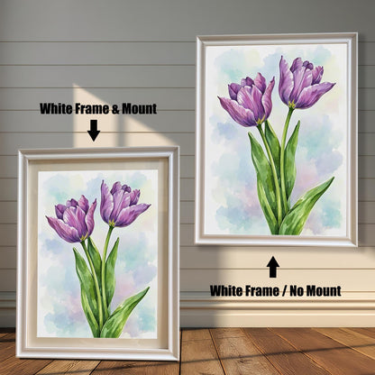 Two framed art prints of purple tulips on a wooden floor. The print on the left is in a white frame with a mount, and the one on the right is in a white frame without a mount.
