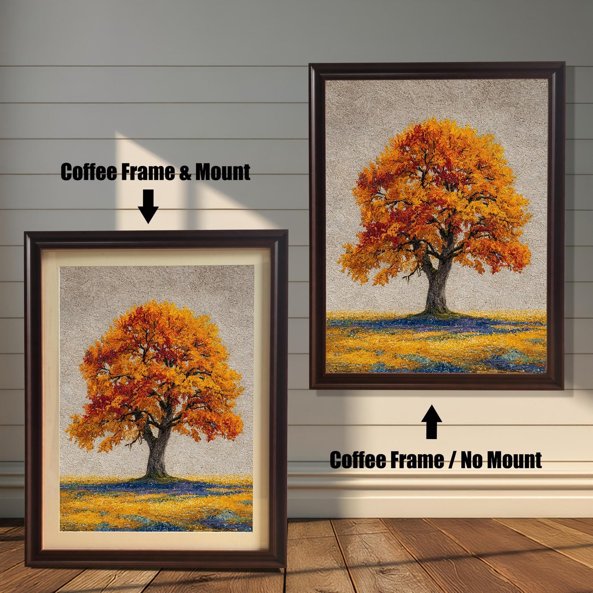Two framed art prints of an autumn tree are on a wooden floor. The print on the left is in a coffee frame with a mount, and the one on the right is in a coffee frame without a mount.