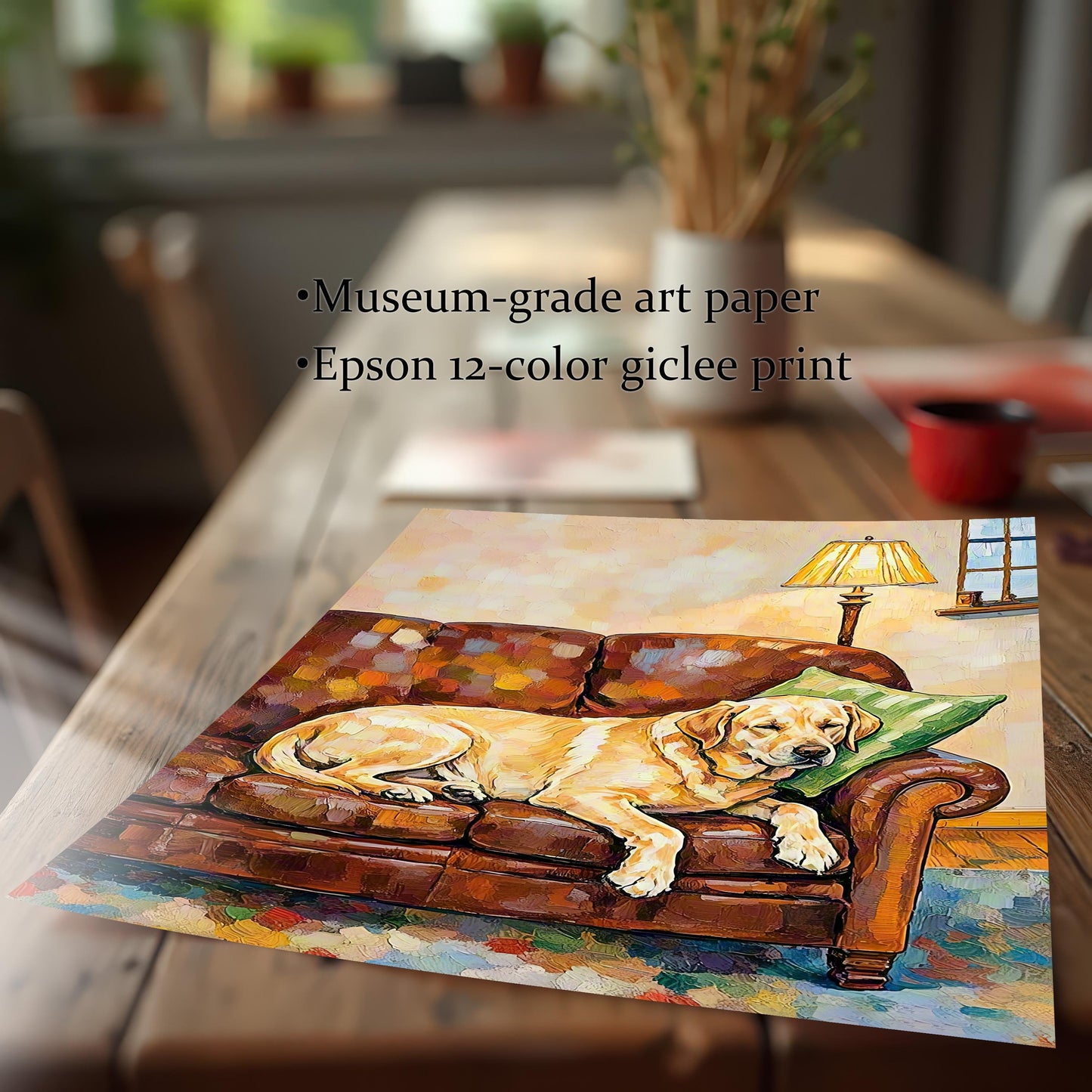 A close-up, angled shot of a print of a yellow labrador dog painting on a brown wooden table, with text describing the paper and printing method.