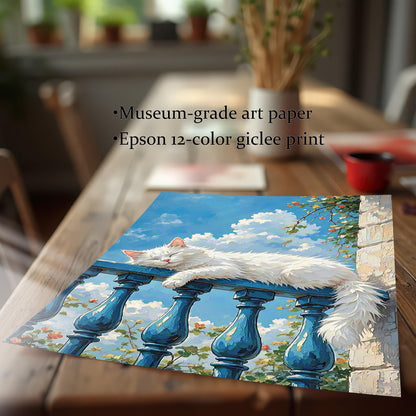 A print of a white cat sleeping on a balcony railing, lying on a wooden table, with text describing it as "Museum-grade art paper."