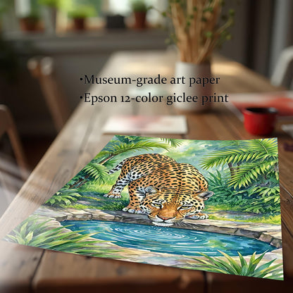 A close-up of an unframed print of a leopard drinking from a pool, resting on a wooden table.