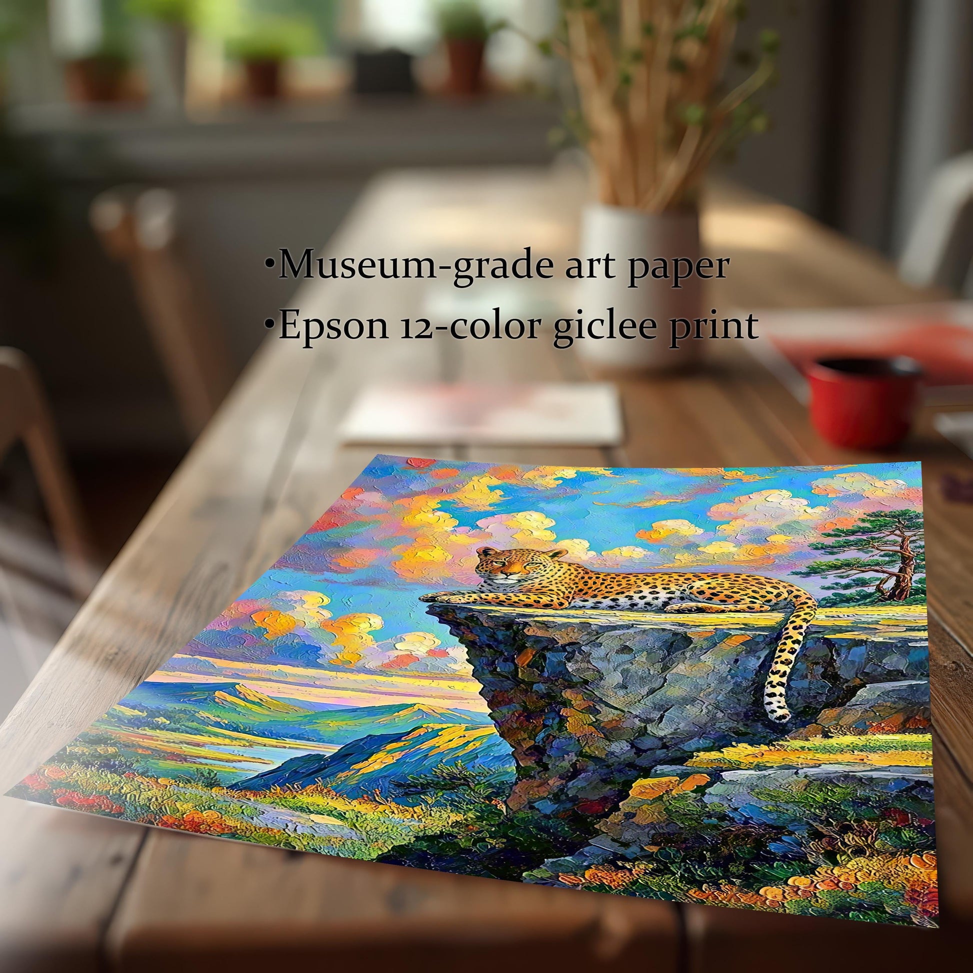 A close-up of an unframed print of a leopard on a cliffside, resting on a wooden table.