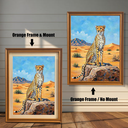 Two framed paintings of a cheetah in a desert. The left one has an orange frame with a mount, and the right one has an orange frame with no mount.