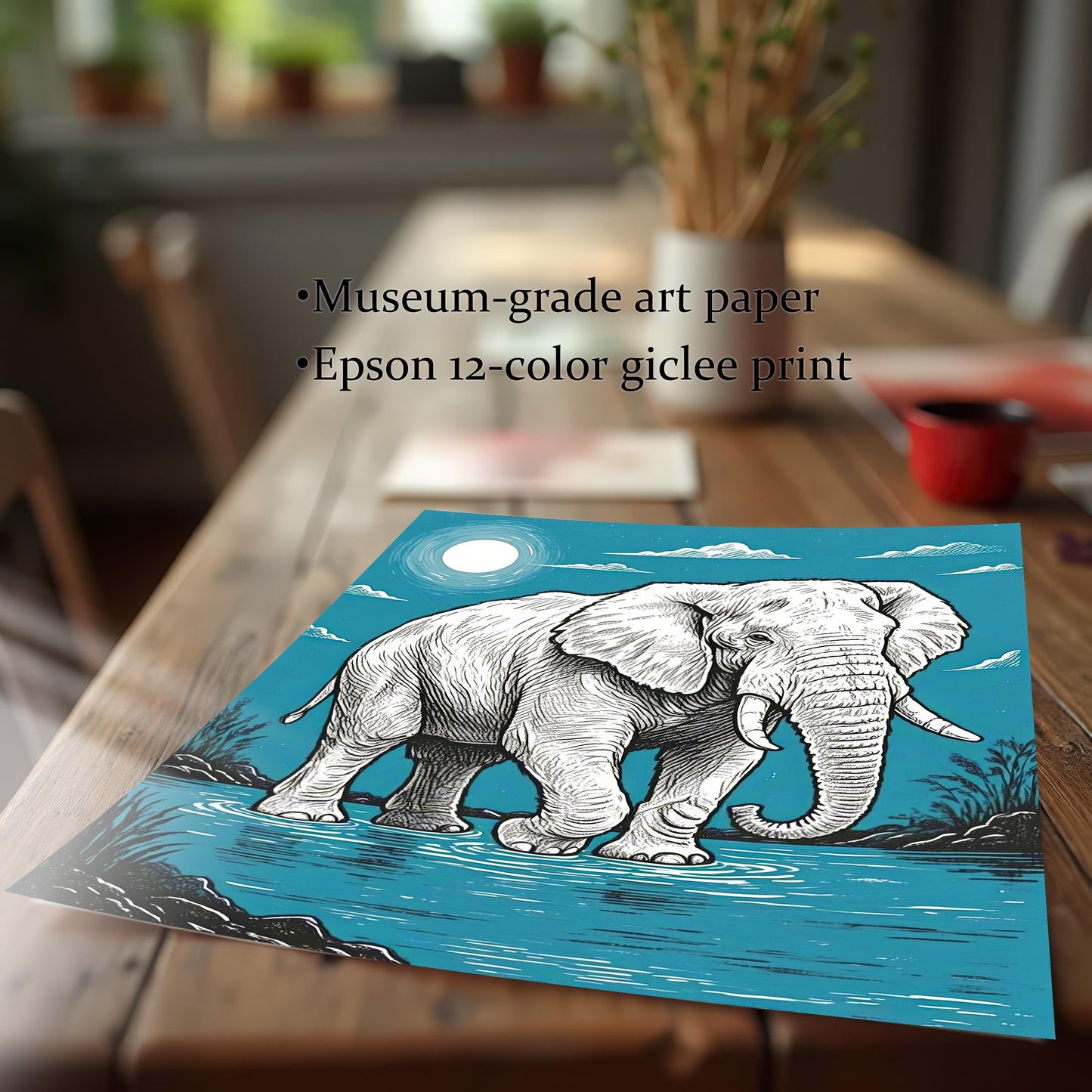 A close-up of a print of a painting of an elephant standing in water, with a full moon in a blue sky, lying on a wooden table.