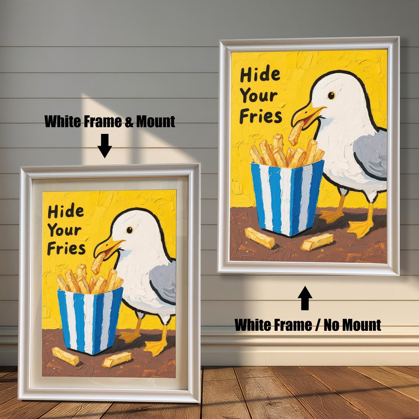 A side-by-side comparison of two framed prints of a seagull and fries. Both prints have a white frame, but one includes a mount, while the other does not.