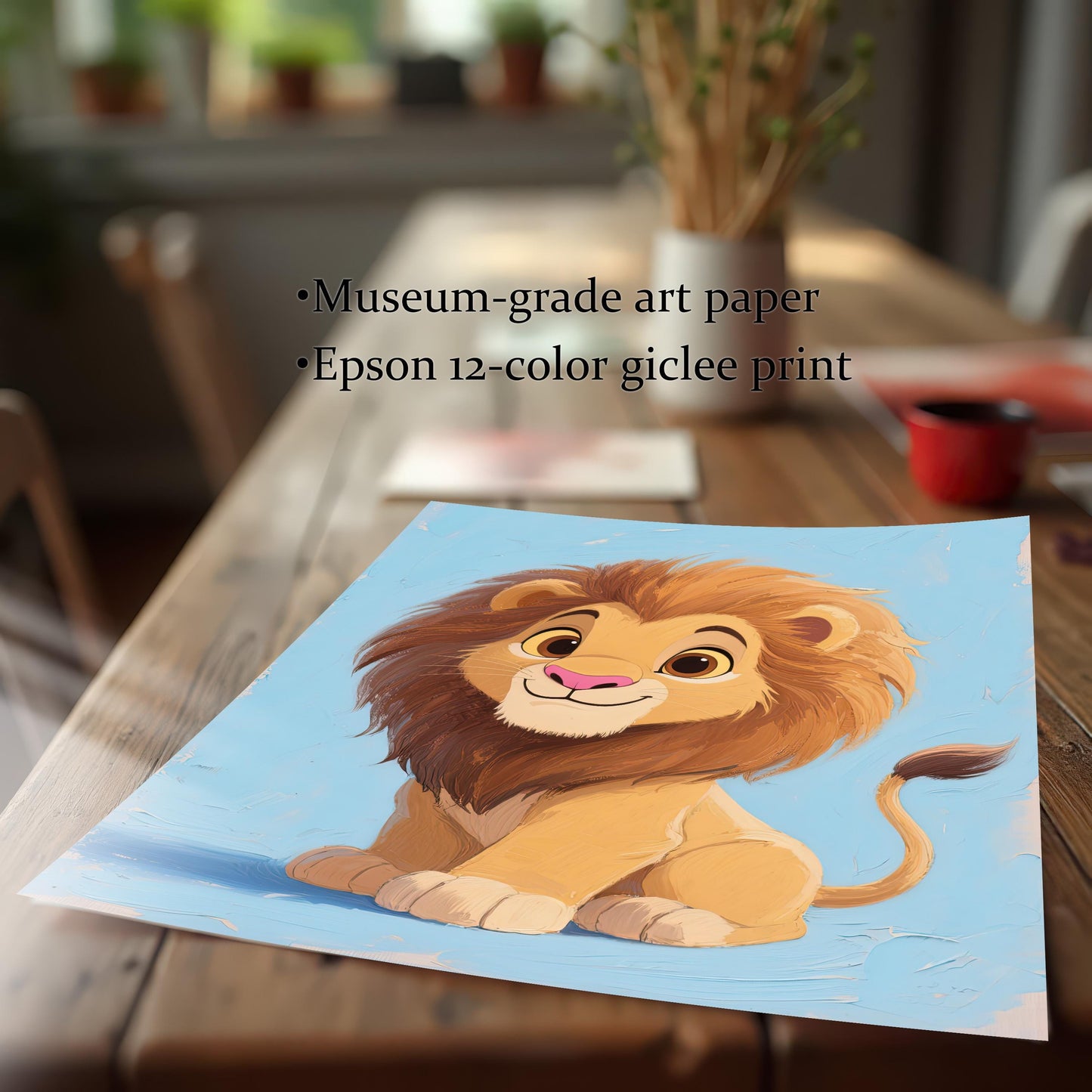 A close-up of an art print of a baby lion, lying on a wooden table. The print is slightly curved at the bottom, highlighting the museum-grade paper and giclée print quality.