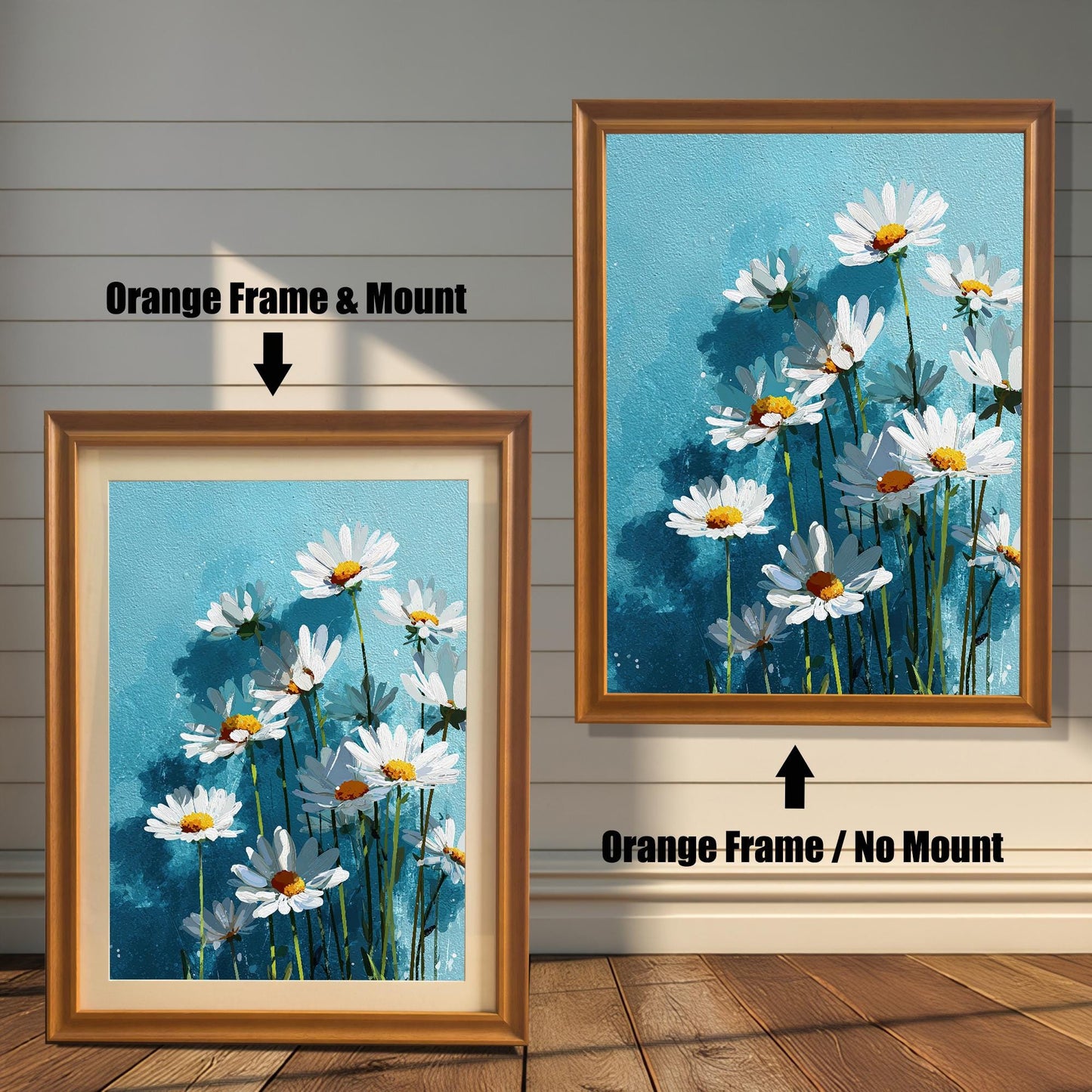Two orange-colored framed art prints of white daisies on a blue background. One has a white mat board and the other does not.