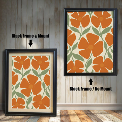 Two black-framed art prints with a repeating pattern of orange flowers and green leaves. One has a white mat board and the other does not.