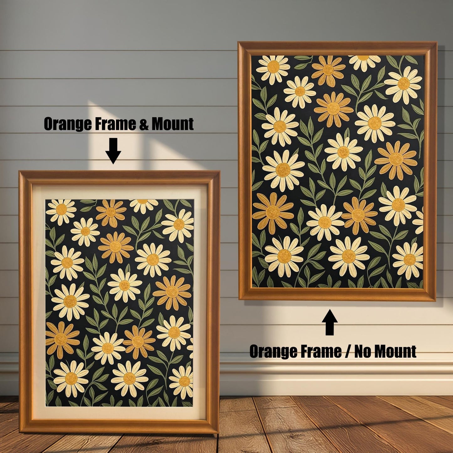 Two orange-colored framed art prints with a pattern of yellow flowers on a dark background. One has a white mat board and the other does not.