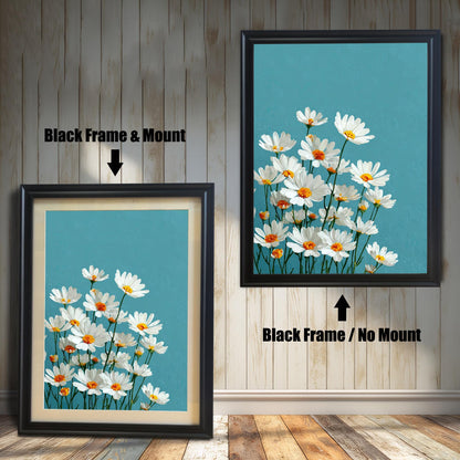 Two art prints of white daisies. The one on the left has a black frame with a white mat. The one on the right has a black frame with no mat.