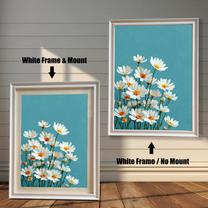Two art prints of white daisies. The one on the left has a white frame with a white mat. The one on the right has a white frame with no mat.