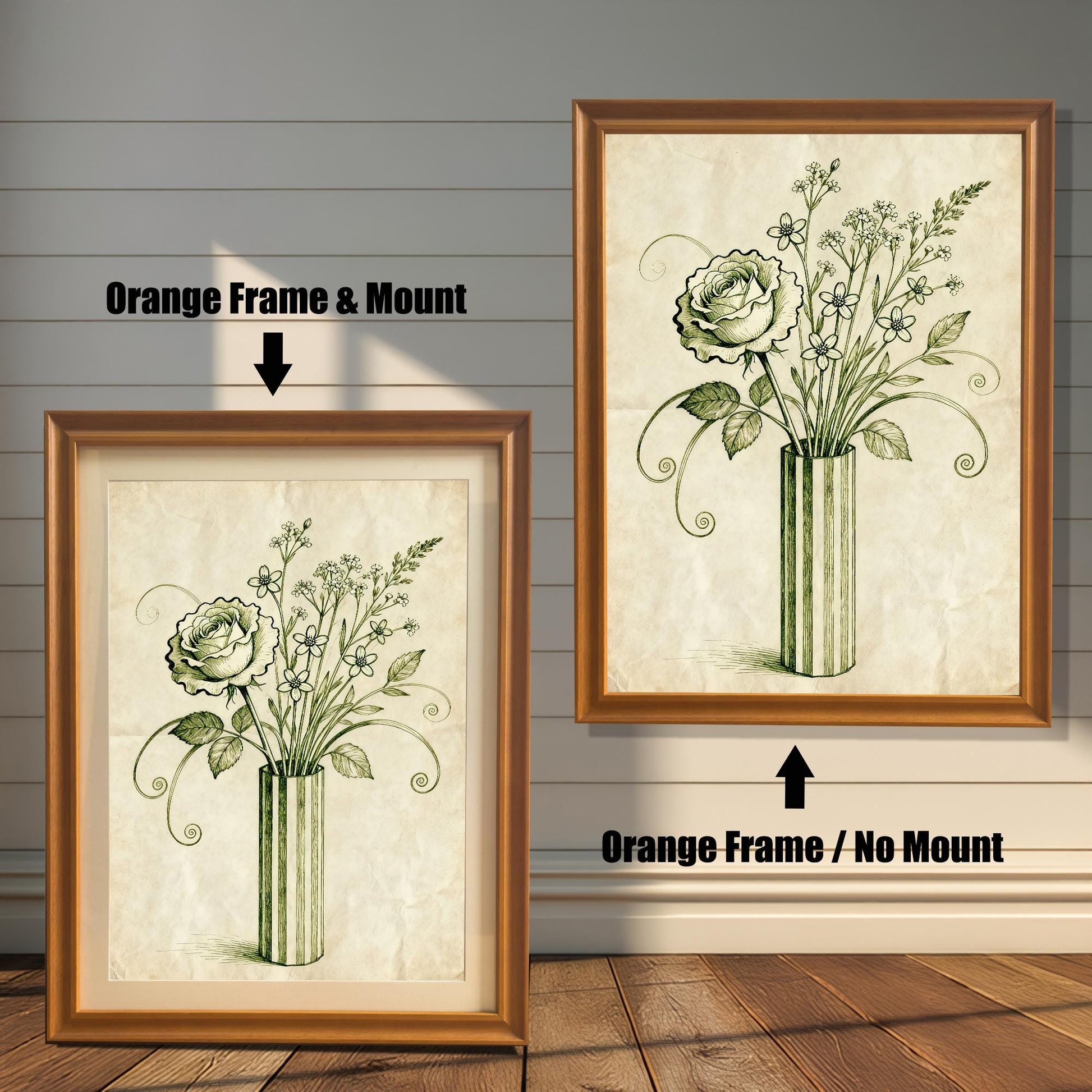 A framed art print of a vintage-style rose and flowers in a vase is shown in two styles against a wooden wall. One has an orange-colored frame with a white mount, the other is a larger size with the same frame, but no mount.