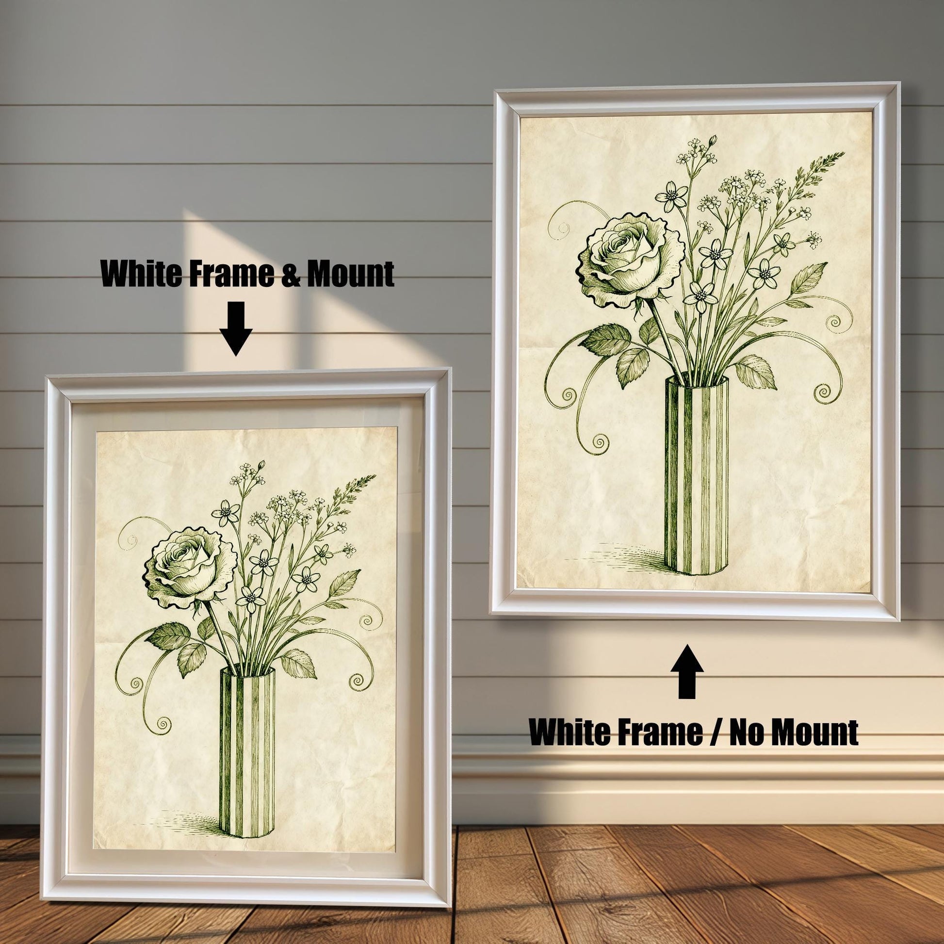 A framed art print of a vintage-style rose and flowers in a vase is shown in two styles against a wooden wall. One has a white frame with a white mount, the other is a larger size with the same frame, but no mount.