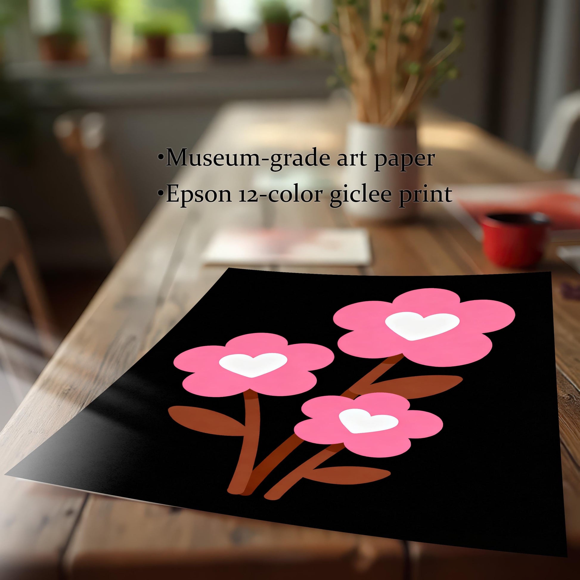A close-up shot of a paper art print of three pink flowers with white hearts lying on a wooden table. Text states the print is on museum-grade art paper using an Epson 12-color giclee process.