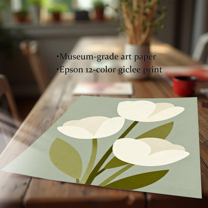A close-up shot of a paper art print of three white tulips lying on a wooden table. Text states the print is on museum-grade art paper using an Epson 12-color giclee process.
