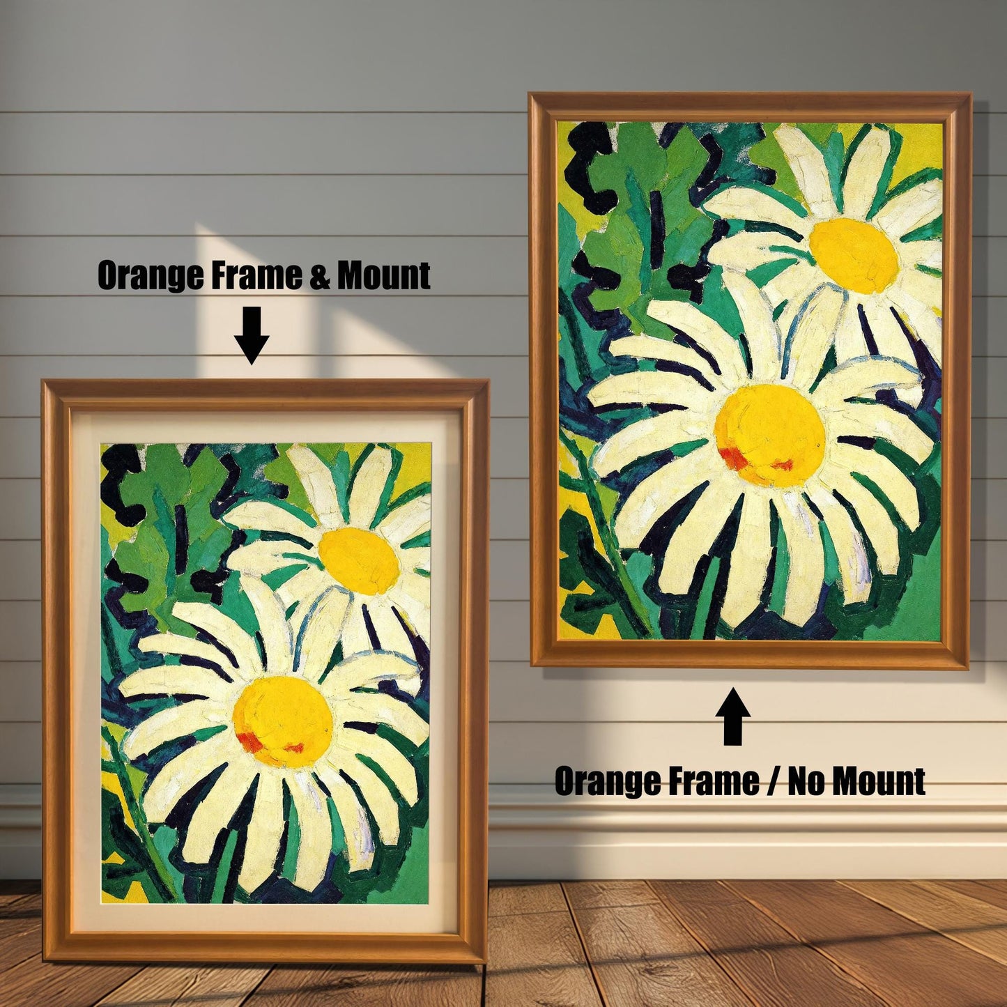 A framed painting of two daisies is shown in two styles against a wooden wall. One has an orange-colored frame with a white mount, the other is a larger size with the same frame, but no mount.