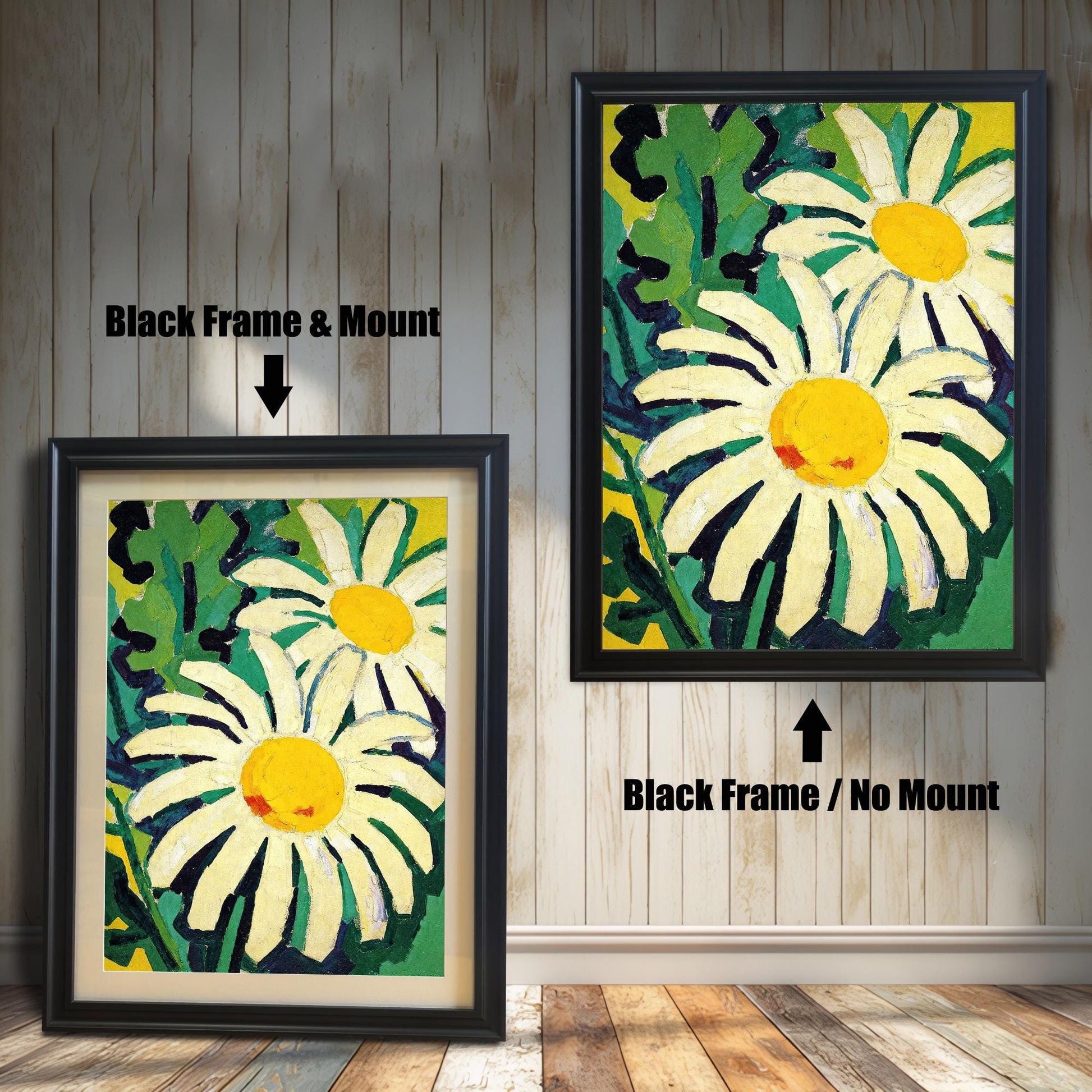 A framed painting of two daisies is shown in two styles against a wooden wall. One has a black frame with a white mount, the other is a larger size with the same frame, but no mount.