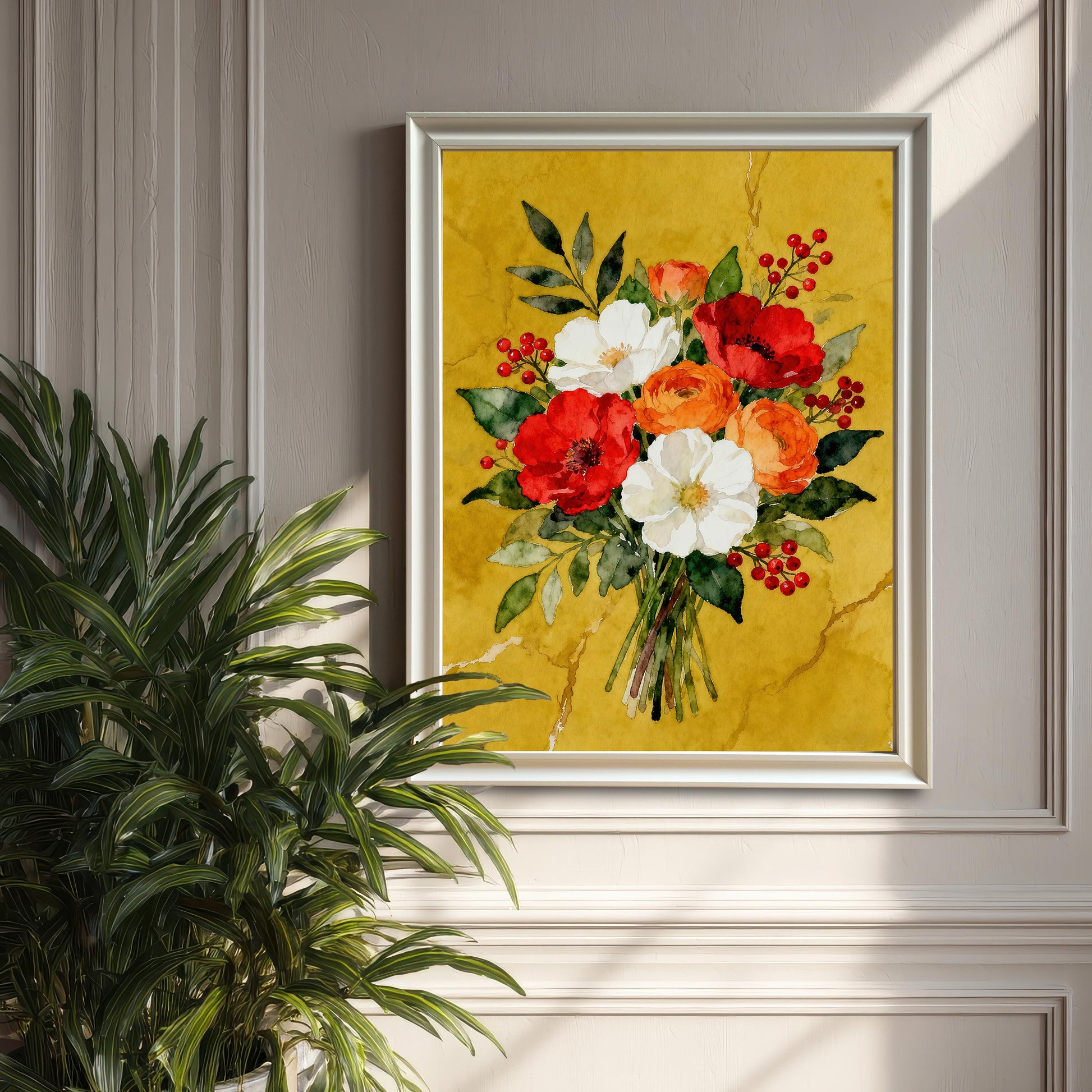 A framed watercolor print of a red, white, and orange floral bouquet in a white frame, hanging on a gray paneled wall next to a large houseplant.