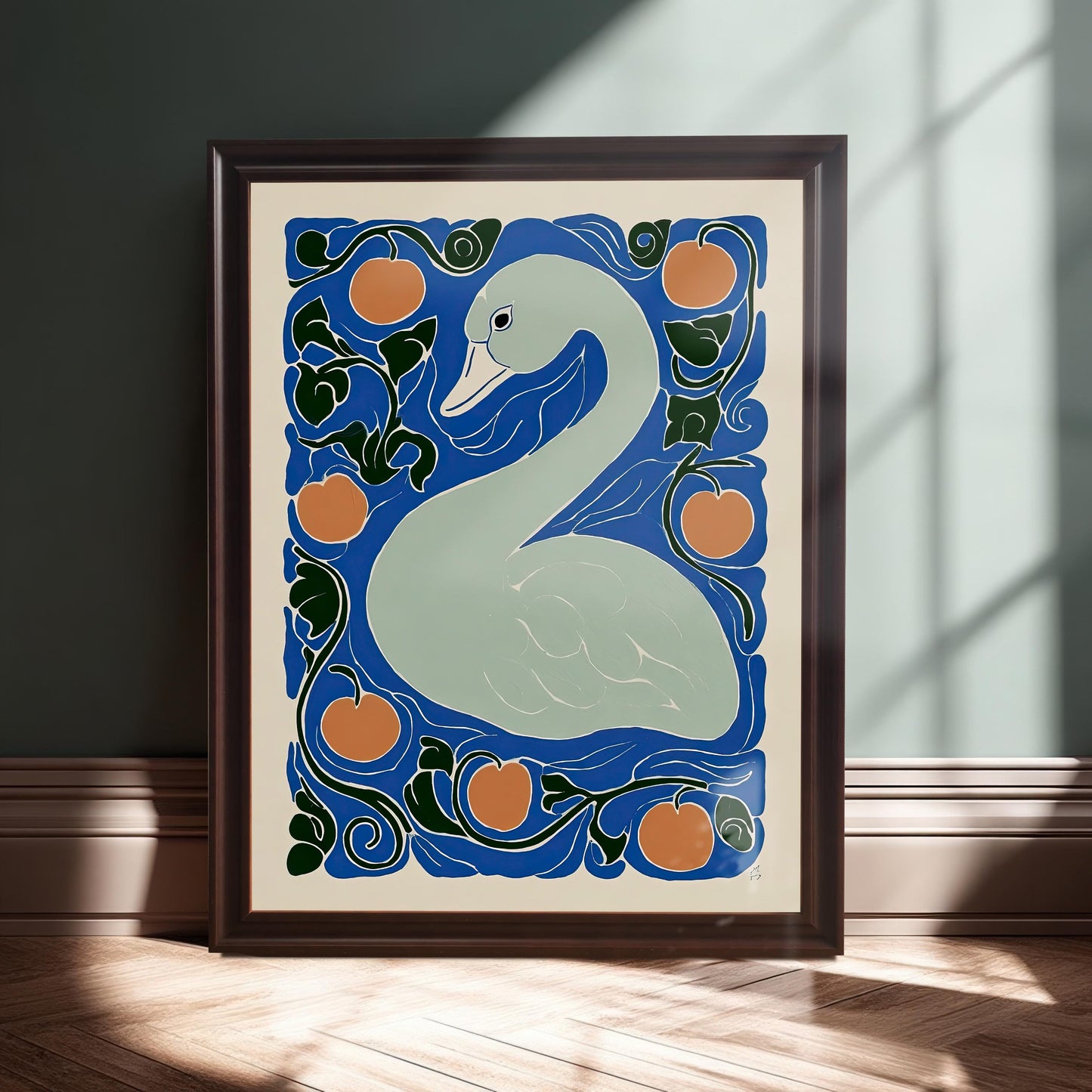 The framed swan print leaning on a baseboard against a dark teal wall, illuminated by a beam of sunlight. The frame is a deep brown or mahogany color.