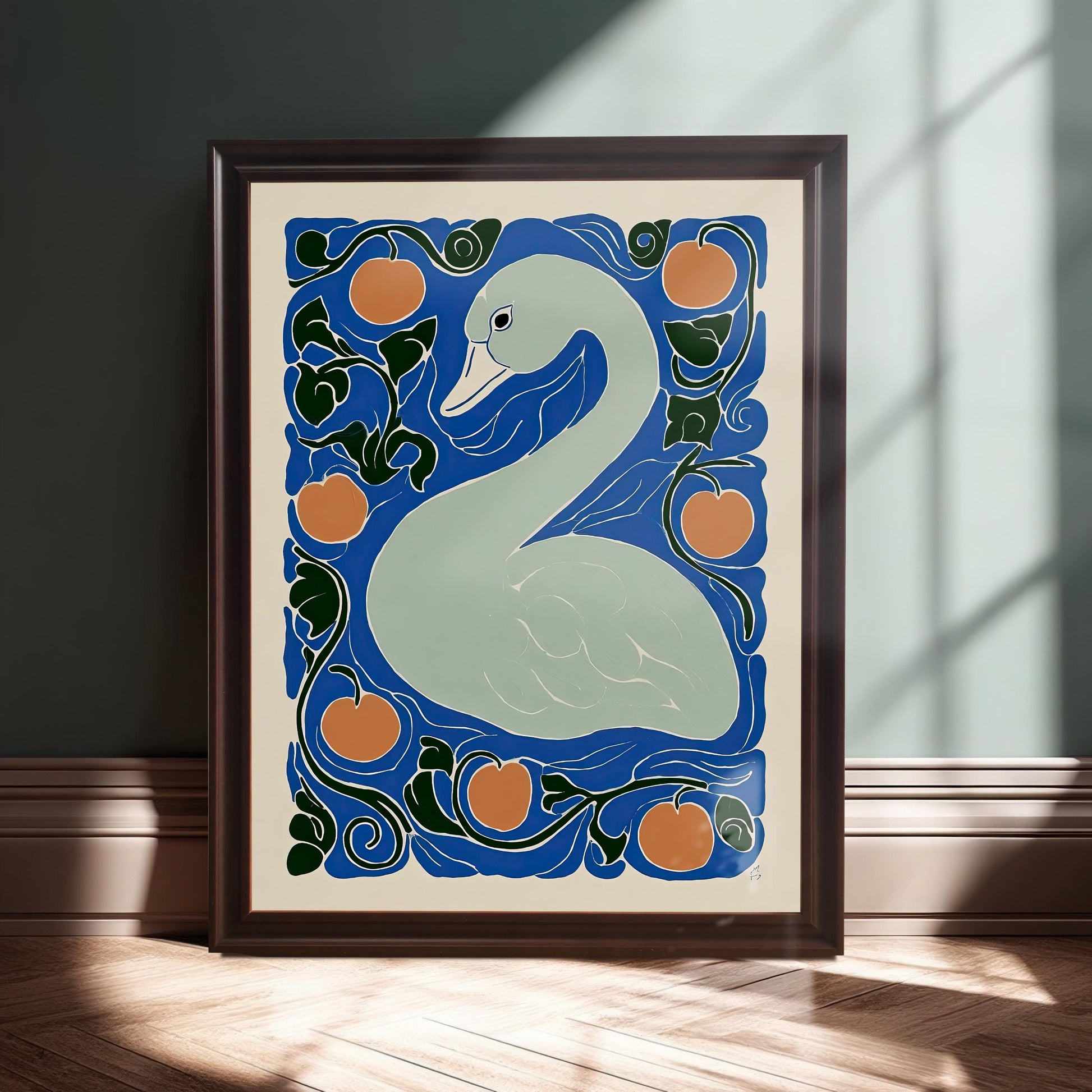 The framed swan print leaning on a baseboard against a dark teal wall, illuminated by a beam of sunlight. The frame is a deep brown or mahogany color.