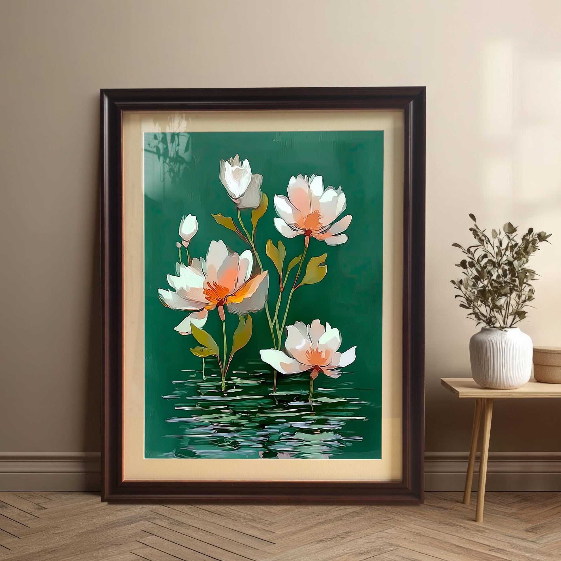 Framed watercolor-style water lily print in a Dark Brown/Coffee frame with a mount (matting), leaning on a wooden floor against a tan wall next to a small wooden side table with a white vase and dried flowers.