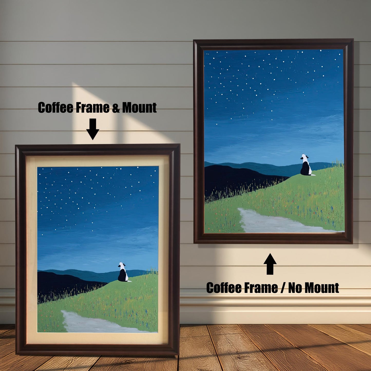 Stylized painting of a black and white dog sitting on a grassy hill under a starry night sky. The image shows two framed options: one on the left with a Coffee Frame & Mount (matting), and one on the right with a Coffee Frame / No Mount. Both are displayed against a white wood-paneled wall and a wooden floor.