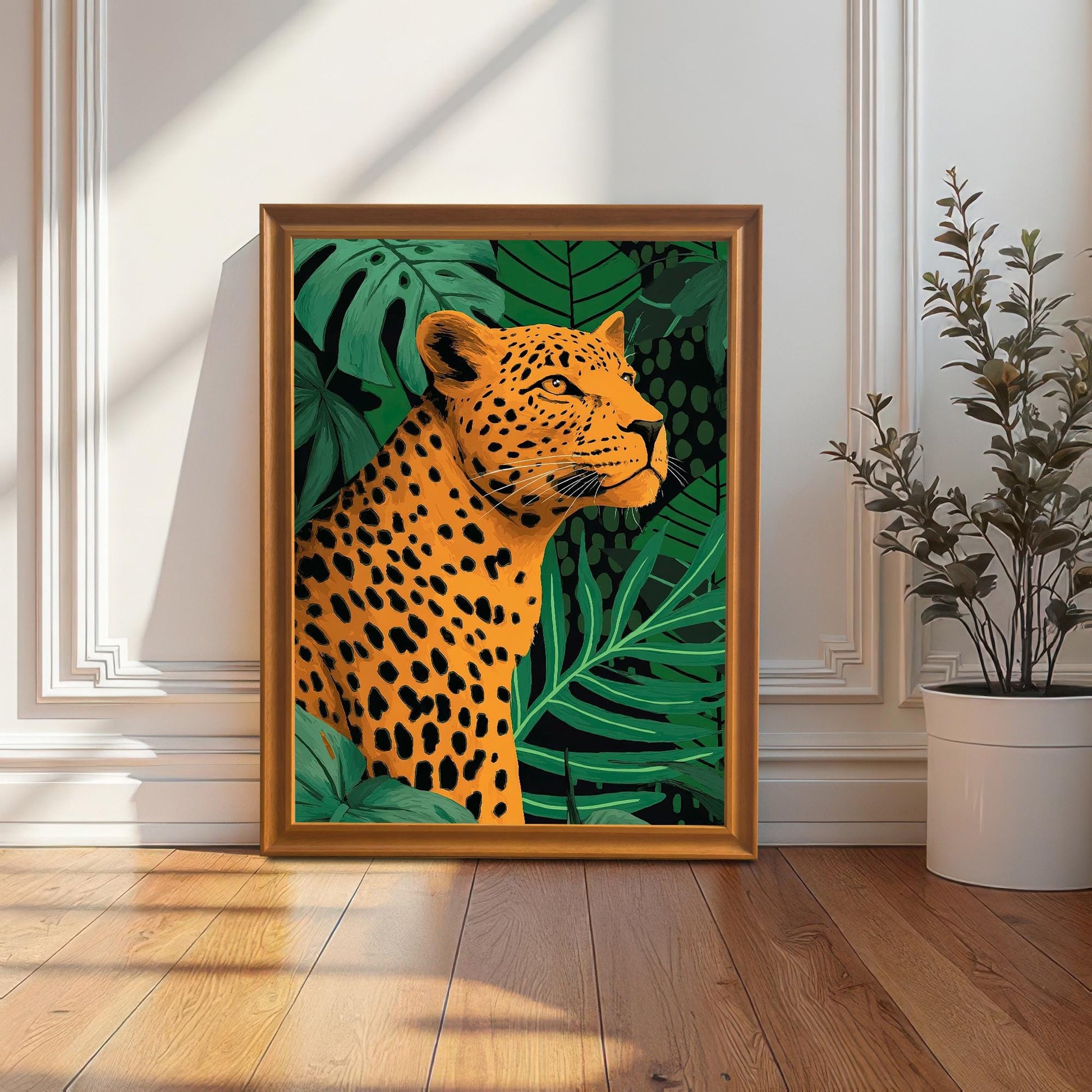 A full-length lifestyle shot of the framed leopard print standing on a wooden floor, leaning against a white wainscoted wall. The print is in an orange/gold wood frame. A potted plant is visible on the right.