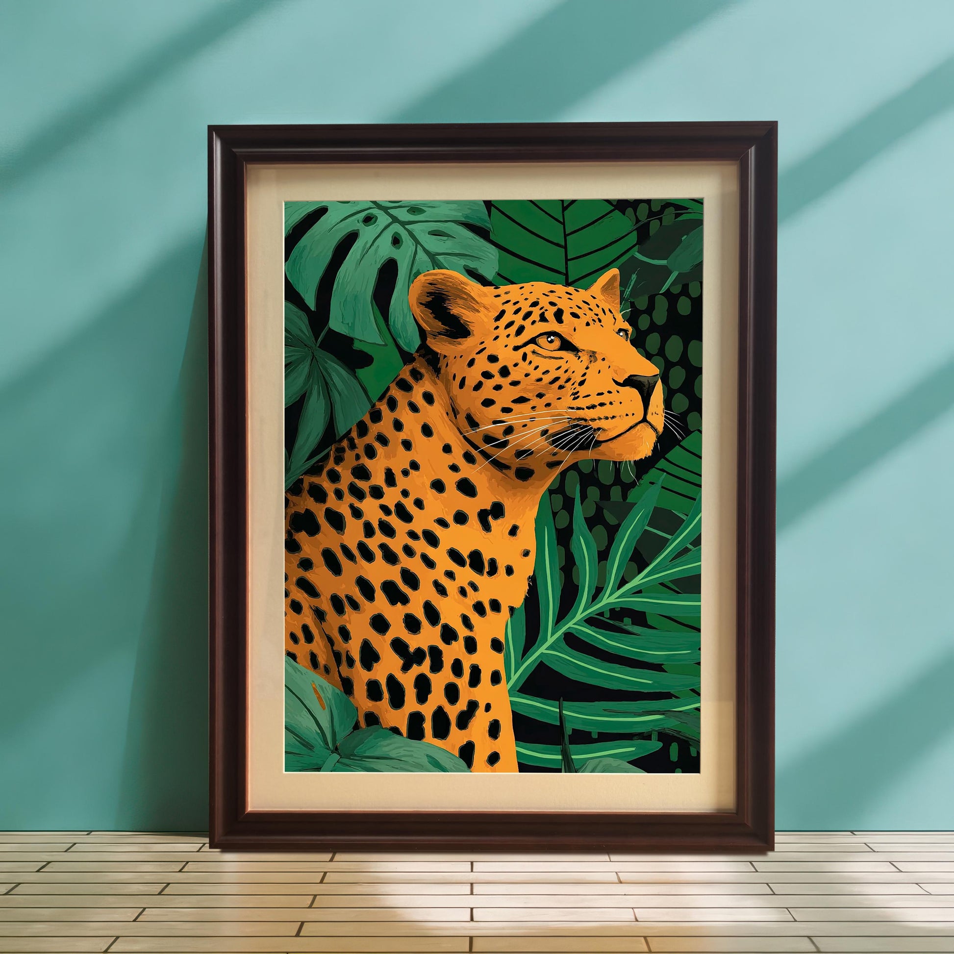 A full-length lifestyle shot of the framed leopard art print standing on a wooden floor with white tile accent, leaning against a light teal or turquoise wall. The print is framed in dark brown/coffee wood with a light-colored mat (mount). Sunlight casts strong vertical shadows on the wall.