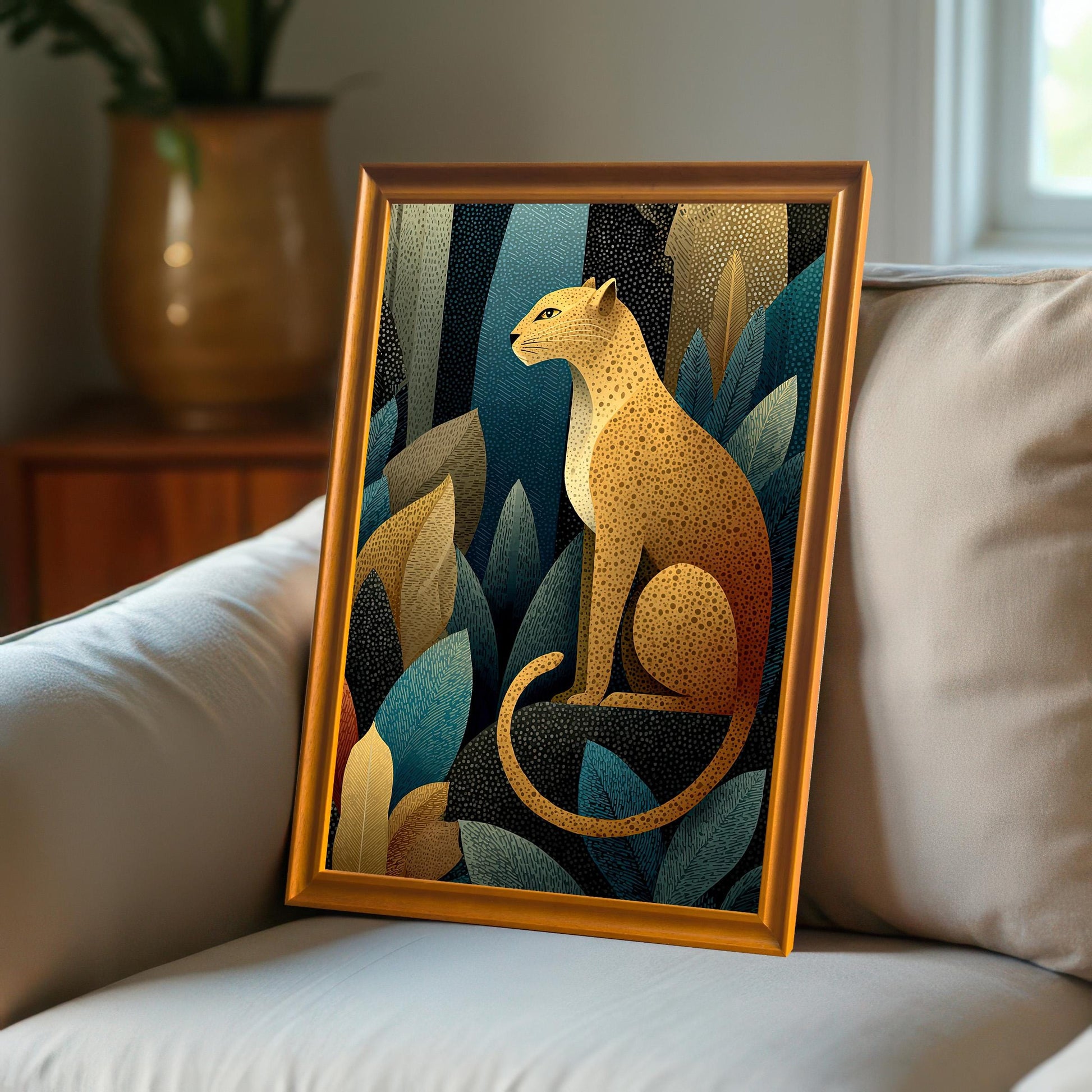 A close-up view of the leopard art print with a light orange-gold frame, resting on a white, textured sofa in a sunlit room.