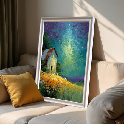 Artwork of a barn in a field under a starry sky, framed in White wood, propped up on a beige sofa next to a yellow pillow in a sunlit room.