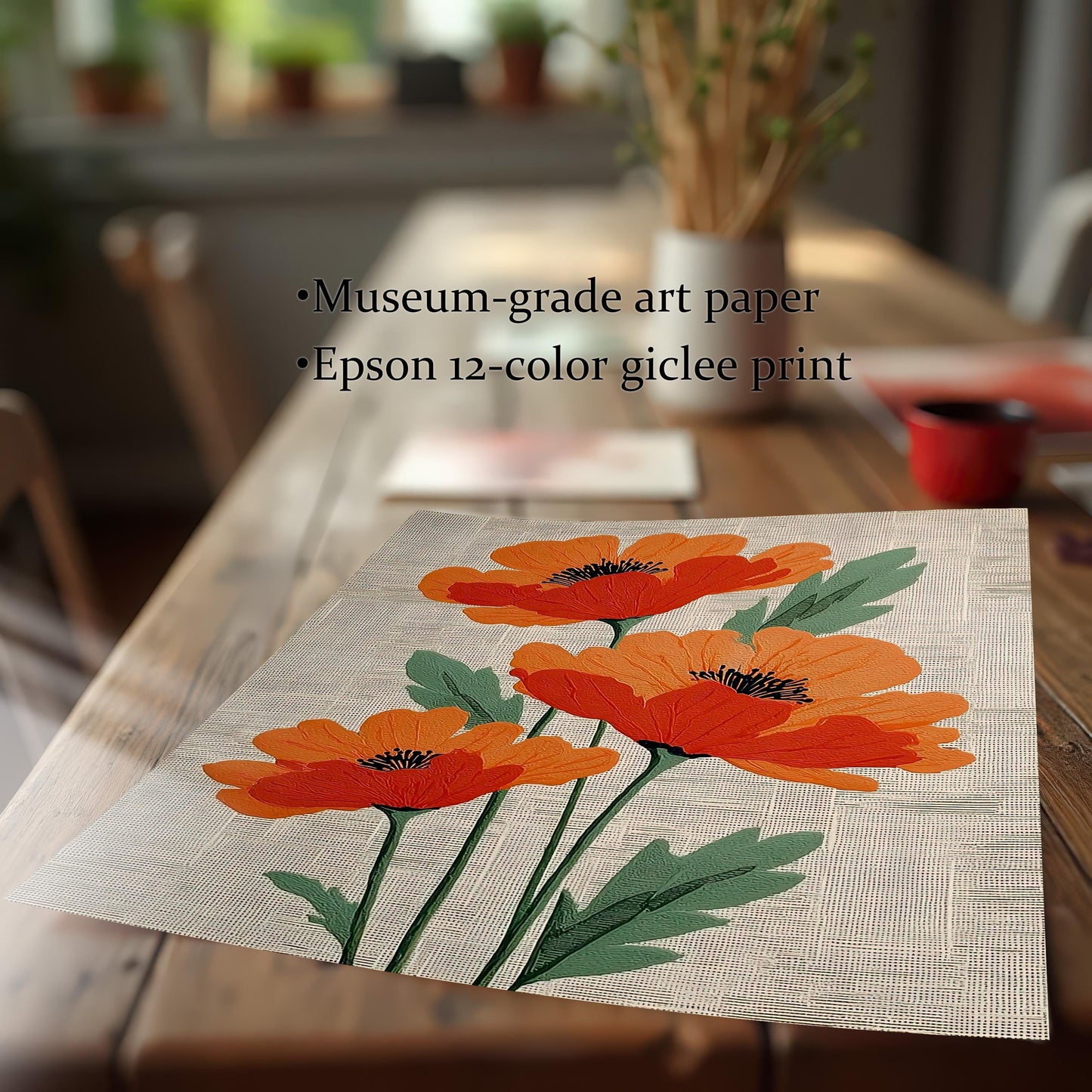 Close-up of the artwork print—three stylized orange poppies on a textured cream background—lying flat on a wooden table. Text states the print features: Museum-grade art paper and Epson 12-color giclee print.