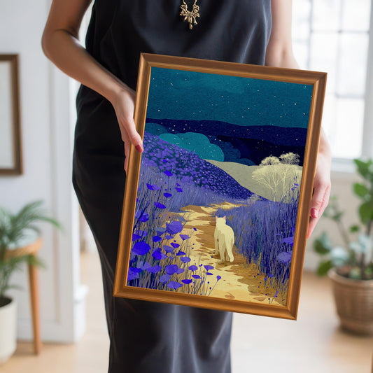 A person in a black dress holds the framed night landscape art print at chest level. The frame is a bright orange-gold. The background is a bright, well-lit interior space.