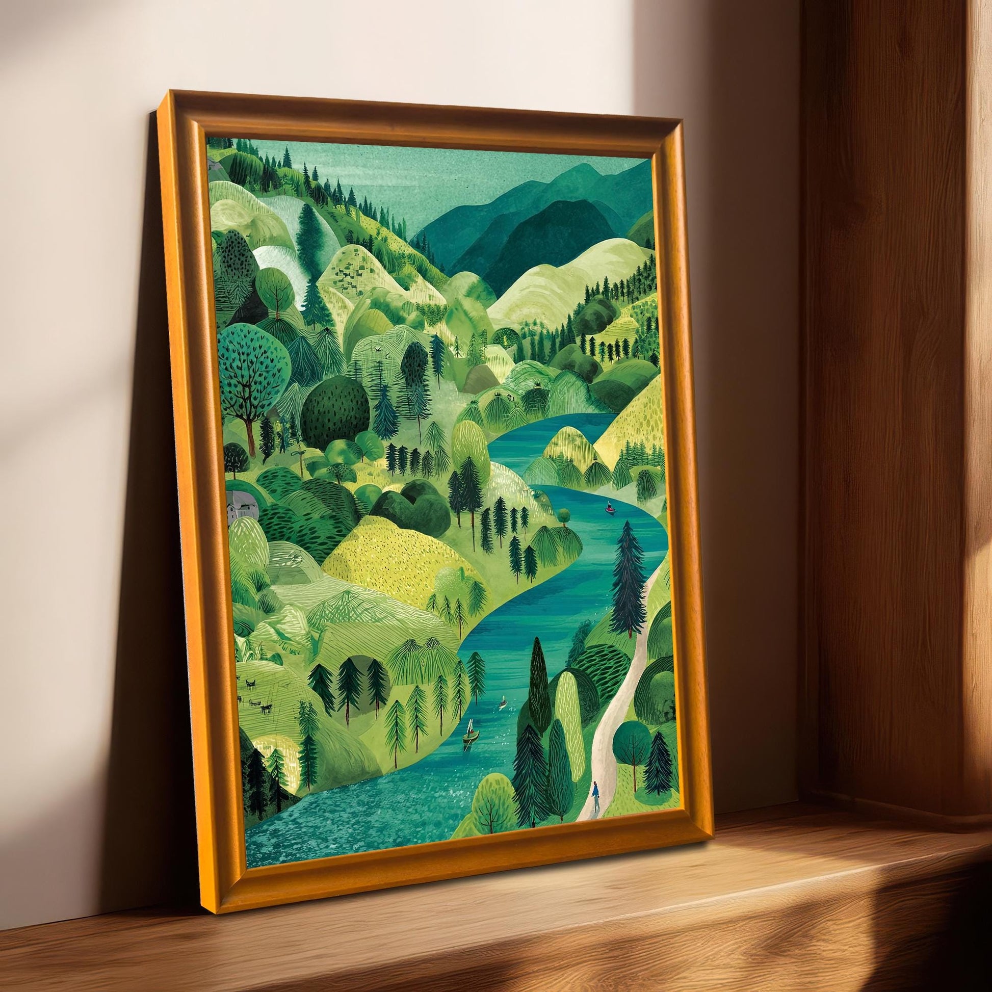 The framed landscape print in an Orange/Gold-colored frame with a mount, leaning on a sunny wooden windowsill.