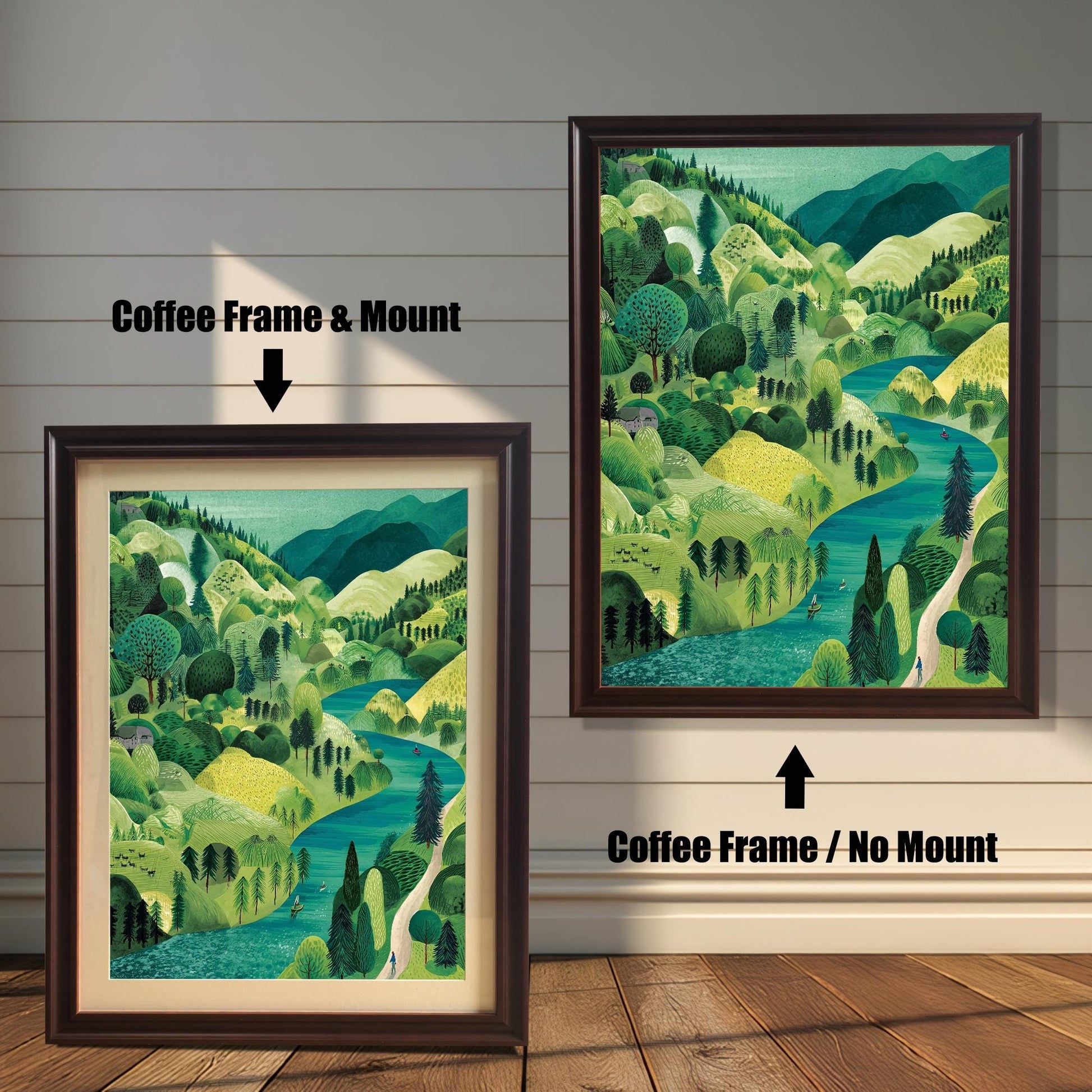 Two versions of the framed landscape print against a distressed white wood background: one on the left in a Coffee Frame & Mount (with a light-colored border), and one on the right in a Coffee Frame / No Mount (without a border). The illustration shows rolling green hills and a turquoise river.