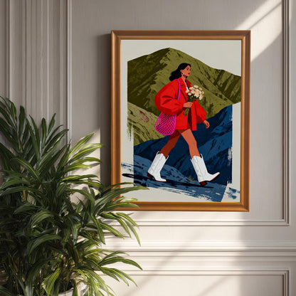 A framed print with an Orange Frame hanging on a gray, panelled wall. A large green houseplant partially obscures the lower left of the frame. Sunlight streams in from the side, highlighting the picture.