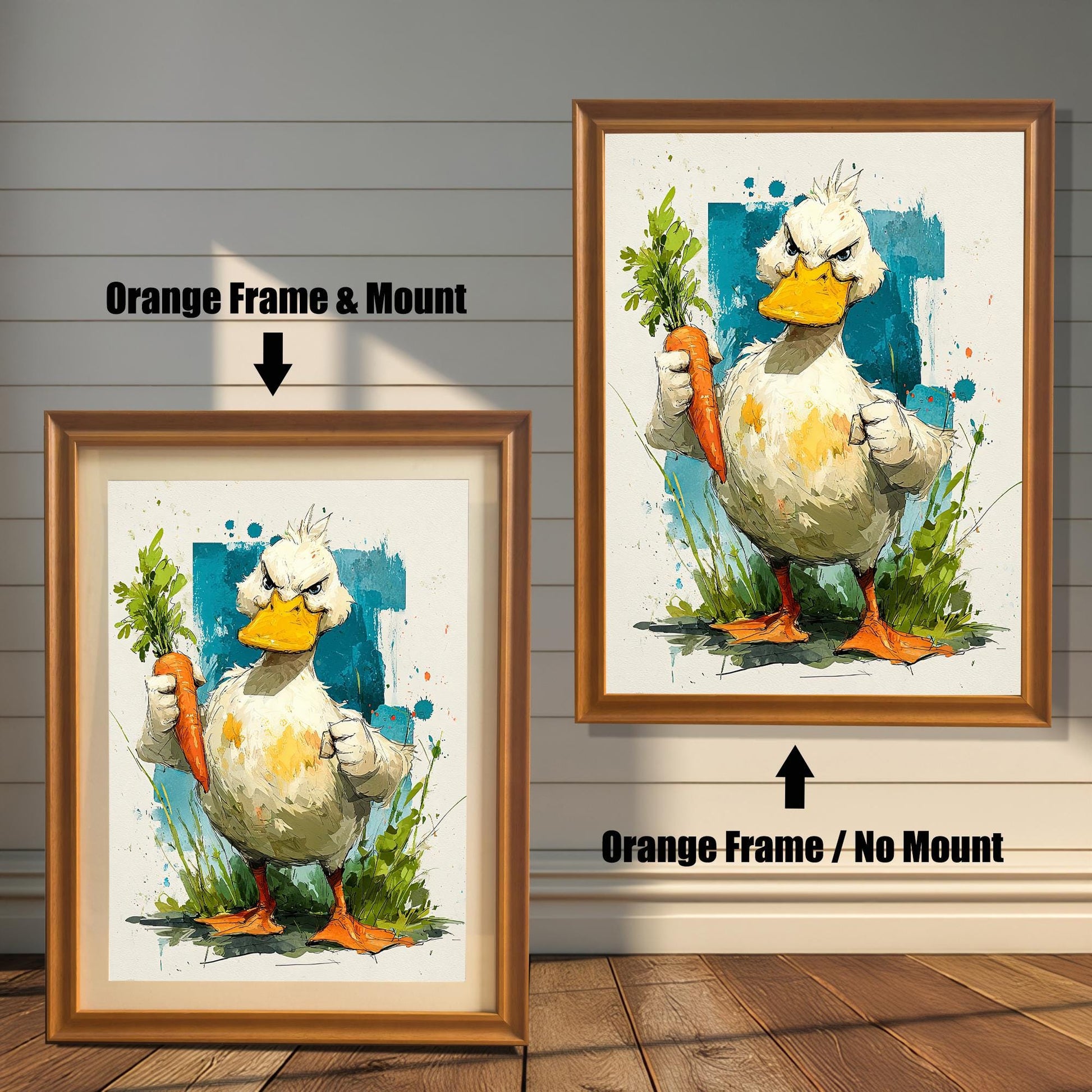 A humorous watercolor-style art print of a very grumpy duck holding a carrot, shown in a gold/orange frame with a mount and a similar frame without a mount.
