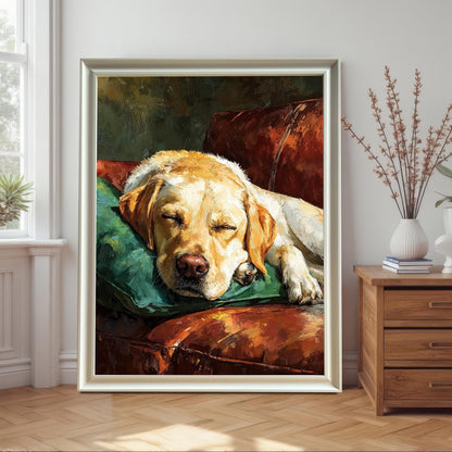 A white-framed painting of a yellow Labrador dog sleeping on a green pillow on a brown leather couch, leaning on a wall next to a wooden nightstand.