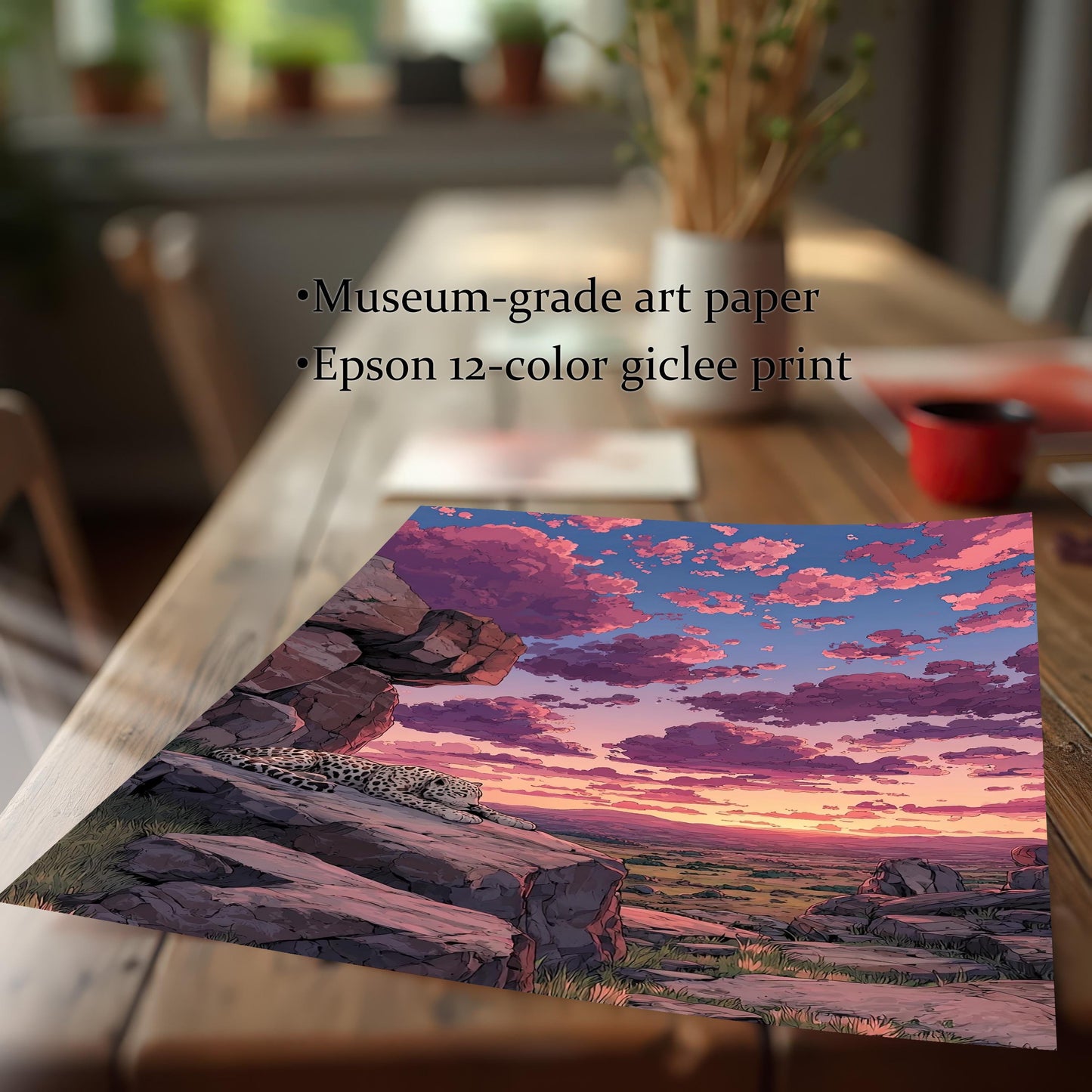 Close-up of an unframed art print on a wooden table, showing a snow leopard on a rocky outcrop at sunset. Bullet points list materials: "Museum-grade art paper," "Epson 12-color giclee print.