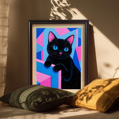 A framed black cat art print in a dark frame, propped up against a wall with pillows in the foreground and a strong sun-drenched shadow.