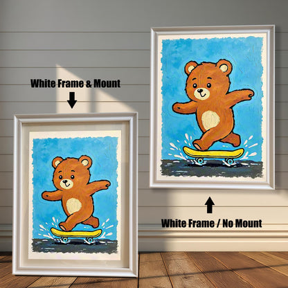 A side-by-side comparison of a framed skateboard-bear art print: one with a white frame and mount (mat), and one with a white frame and no mount.