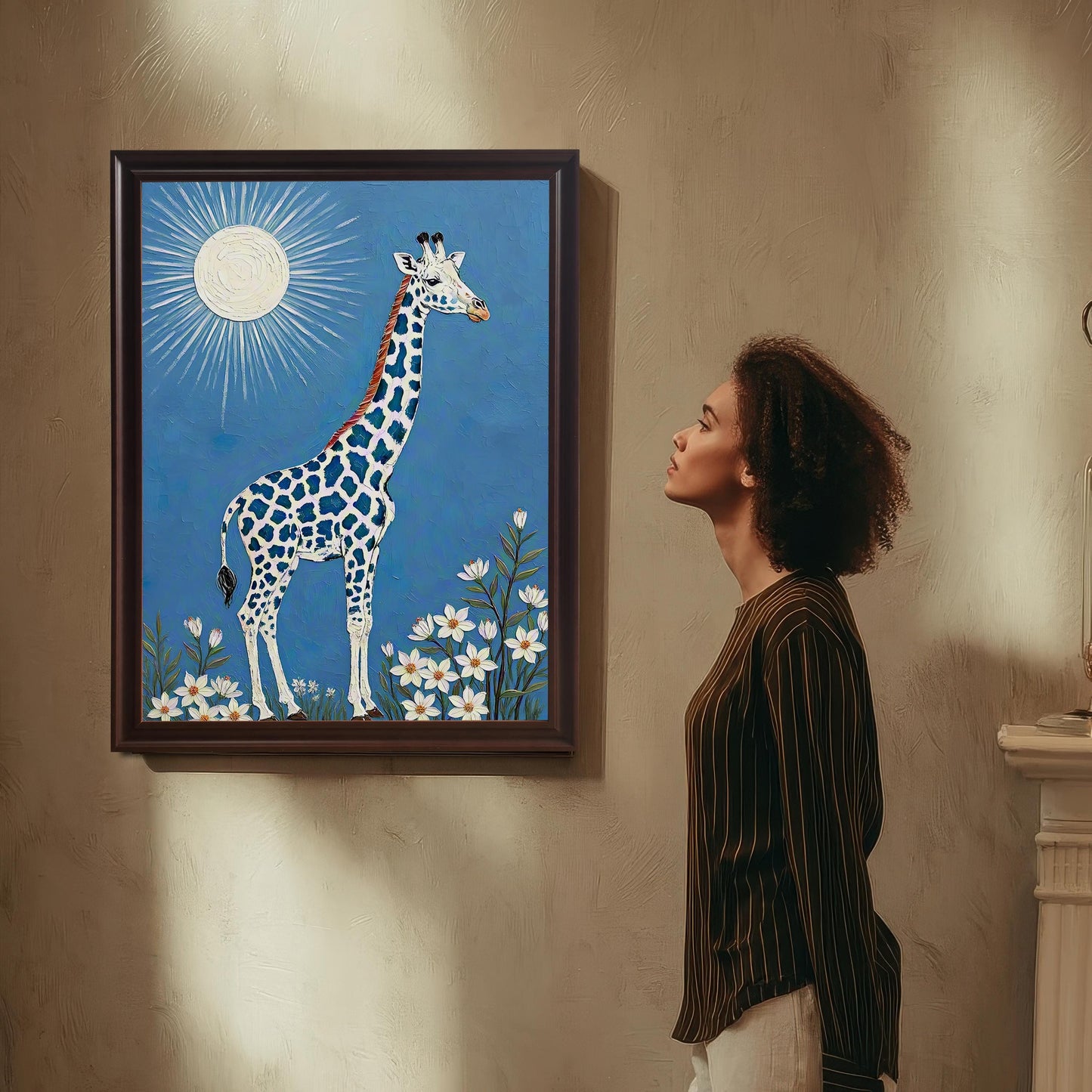 A person with curly hair looks up at a framed giraffe print with a **Coffee Frame / No Mount** hanging on a textured, beige wall. |