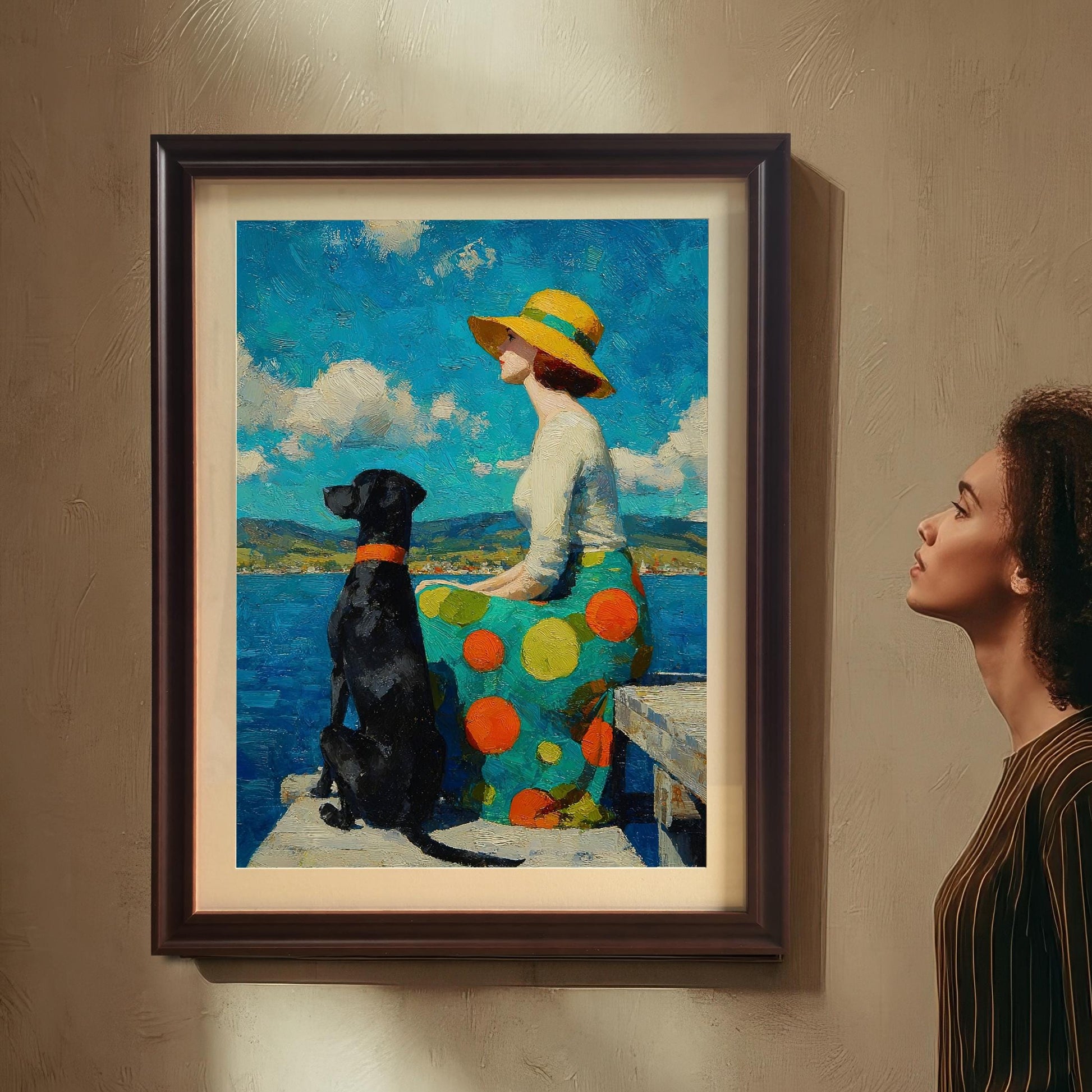 A woman in a striped shirt stands, looking up at a framed painting of a woman and her dog hanging on a beige wall.