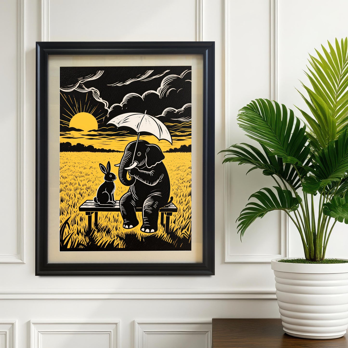 A black-framed print of an elephant holding an umbrella next to a rabbit on a bench, hanging on a white paneled wall beside a houseplant.