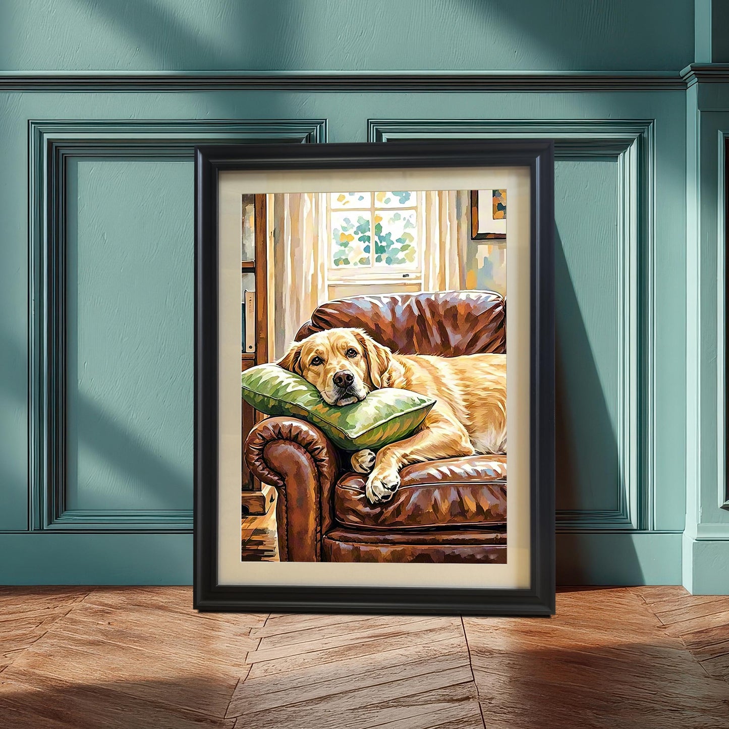 Black-framed painting of a Labrador on a couch, leaning on a wooden floor against a paneled teal wall.