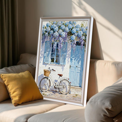 Framed print in a White frame leaning on a light-colored sofa next to a yellow pillow, showing sunlight and shadows.