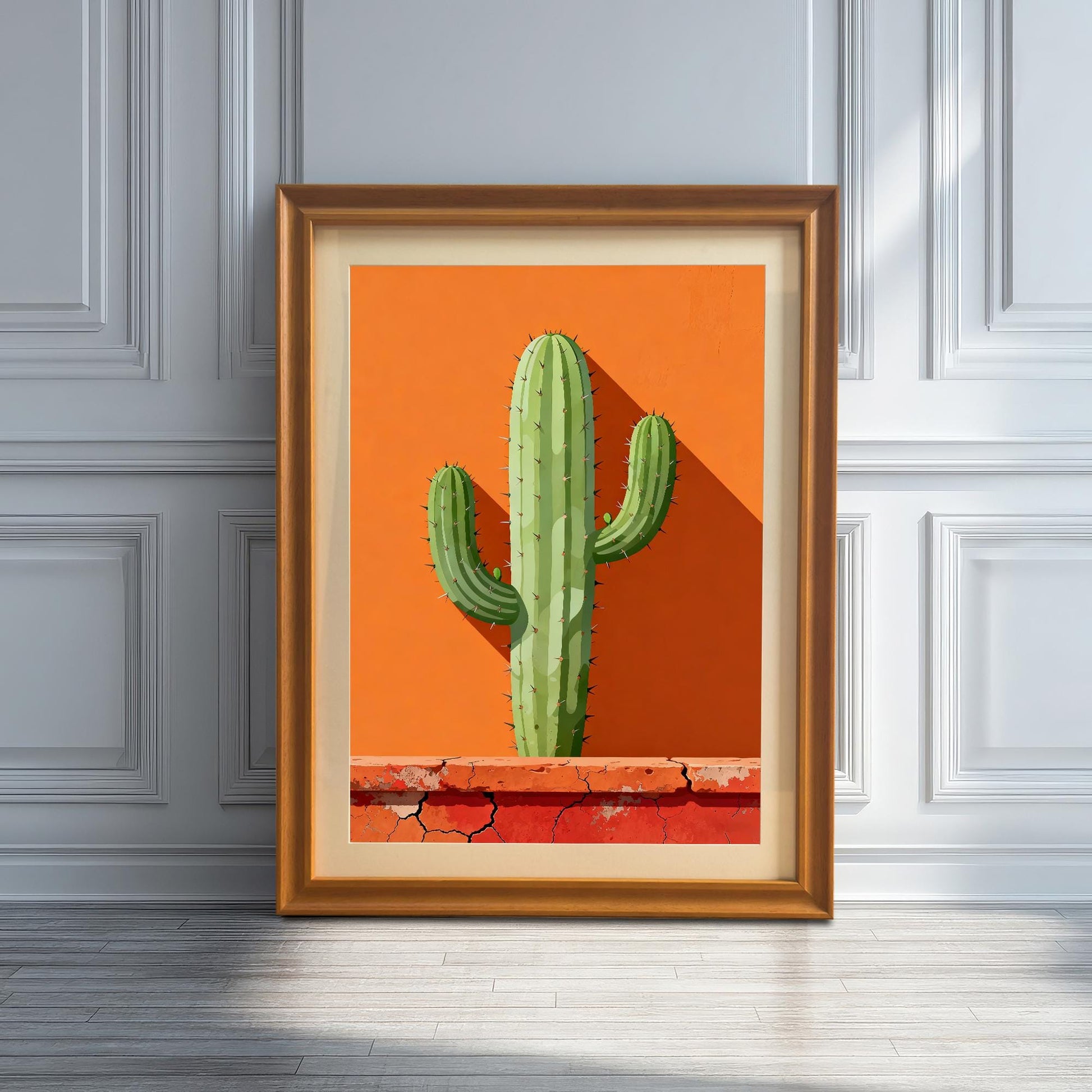 Single framed art print in an Orange wood frame with a mount leaning against a white wainscoted wall, featuring a green cactus against a vibrant orange background with a terracotta base.