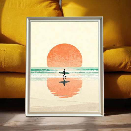 Vertical art print featuring a minimalist sunset beach scene with a silhouette of a surfer walking, framed in Silver/White with No Mount. The art is leaning on a wooden floor against a bright mustard-yellow couch, highlighting the print's warm color palette.