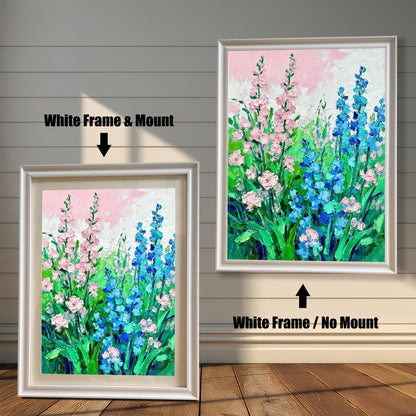 Abstract floral art print featuring pink and blue flowers, shown in two framed options: a White Frame with a Mount (lighter border/mat) on the left, and a White Frame with No Mount on the right.